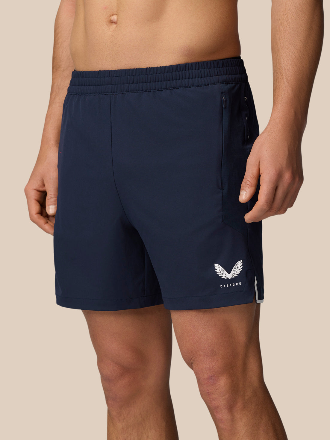 Navy Apex 6 inch training shorts with elastic waistband drawcord, zip pocket and Castore logo at the hem