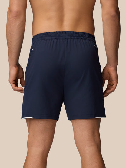 Back view of a man wearing Apex Training Shorts in Midnight Navy with an elastic waistband