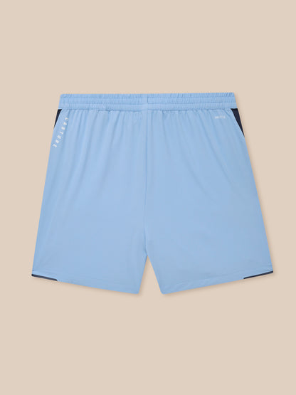 Back view of sky blue Apex Training Shorts with navy side panels and Protek branding at the waistband