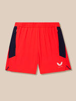 Side-back view of red shorts showing navy panels and Castore branding near the leg hem