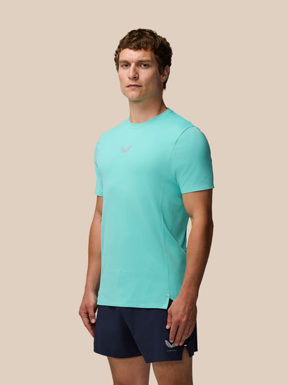 Full-body side view of a man in Zone Training T-Shirt Light Aqua with navy shorts.