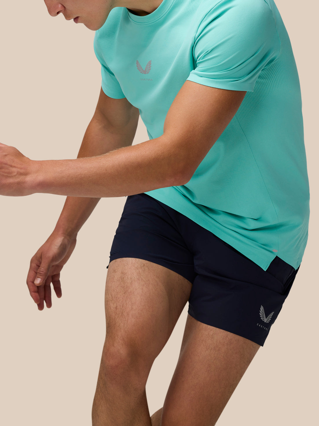 Close-up of a man in Light Aqua Zone Training T-Shirt highlighting fabric texture and chest logo.