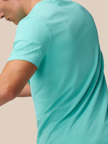 Model wearing Zone Training T-Shirt Light Aqua shown from the side, highlighting back ribbing for mobility.
