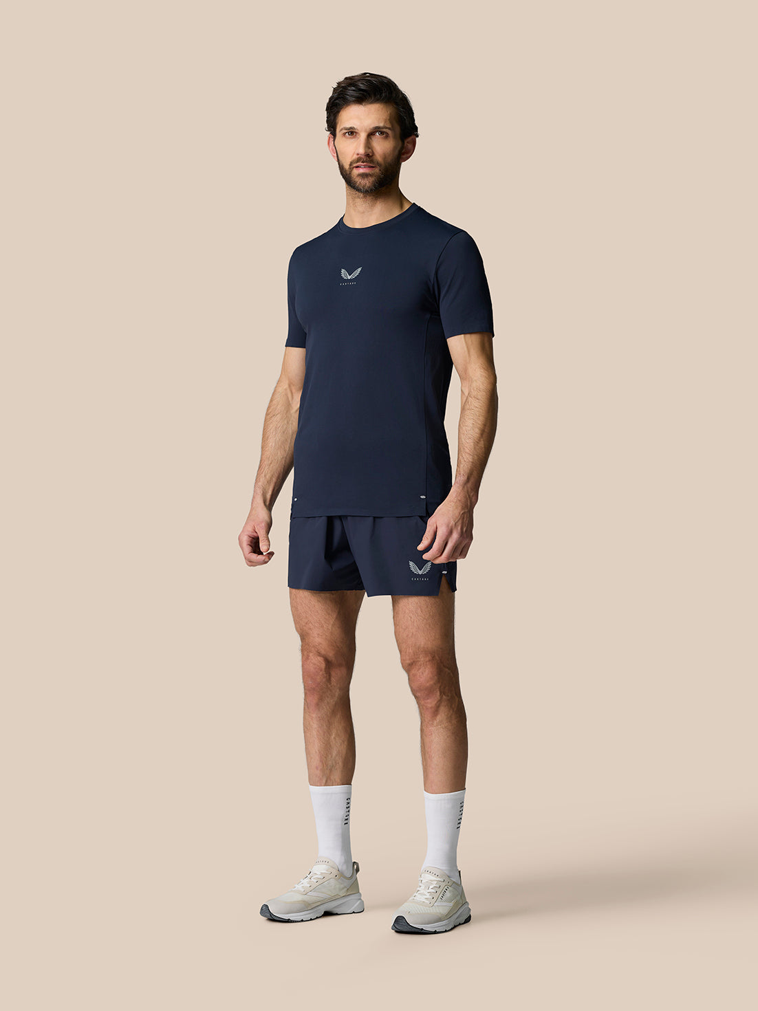 Male model wearing Zone Training T Shirt Midnight Navy with matching shorts, showcasing a classic crew neck and reflective trims.