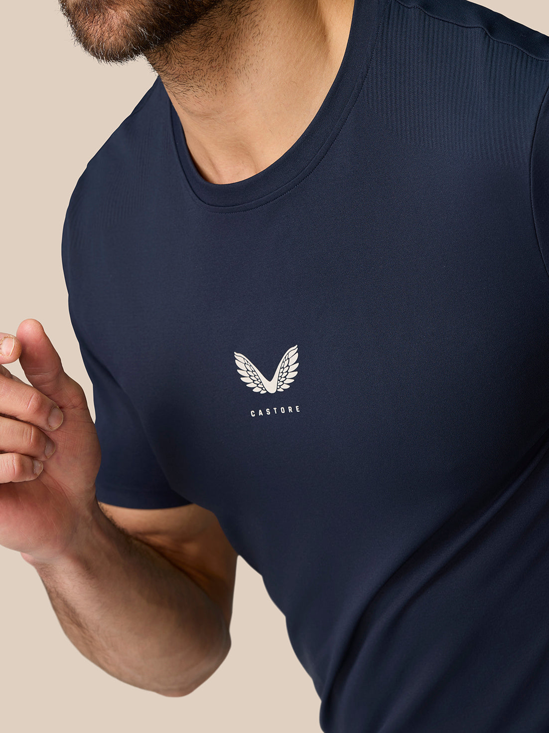 Close-up of navy Zone Training T-Shirt chest logo featuring a white wing emblem