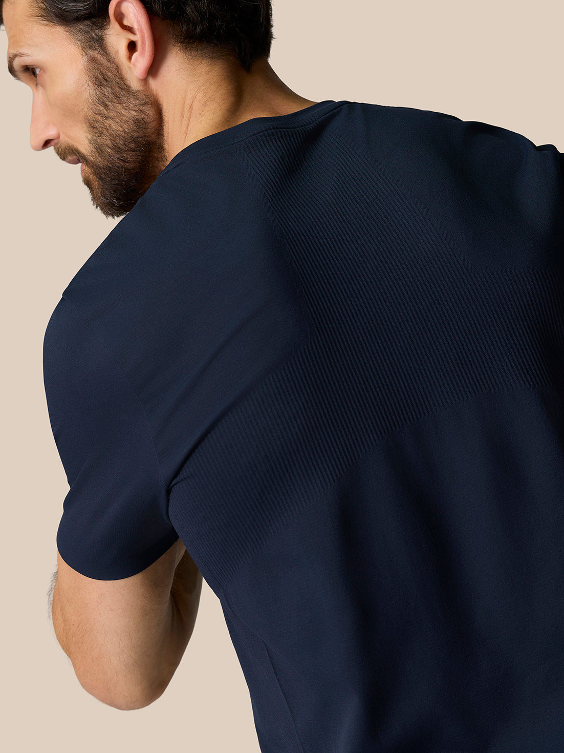Male model wearing Zone Training T-Shirt Midnight Navy from the back, highlighting ribbed shoulder panels