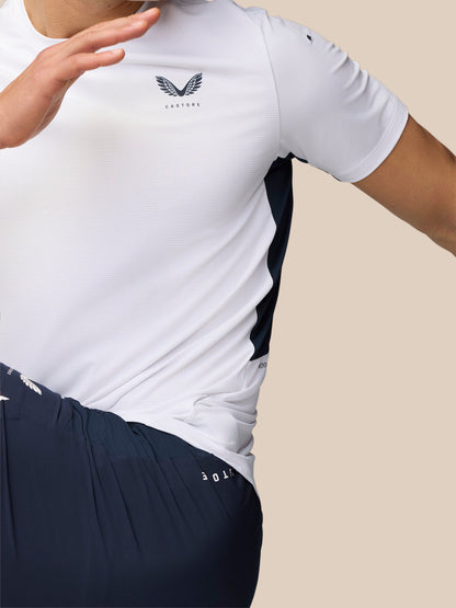 Side view close-up of the white Apex Training T-Shirt with logo on the chest and navy side panels.