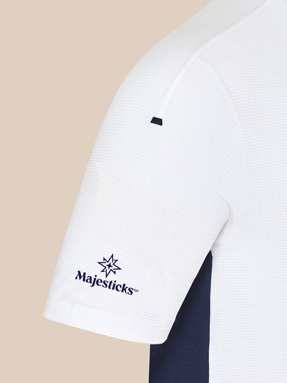 White Majesticks golf T-shirt sleeve close up showing grid fabric navy side panel and Majesticks logo on the sleeve
