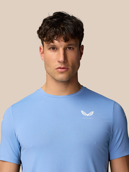 Front view of a man wearing Sky Blue Apex Training T-Shirt with white Castore wing logo on the left chest