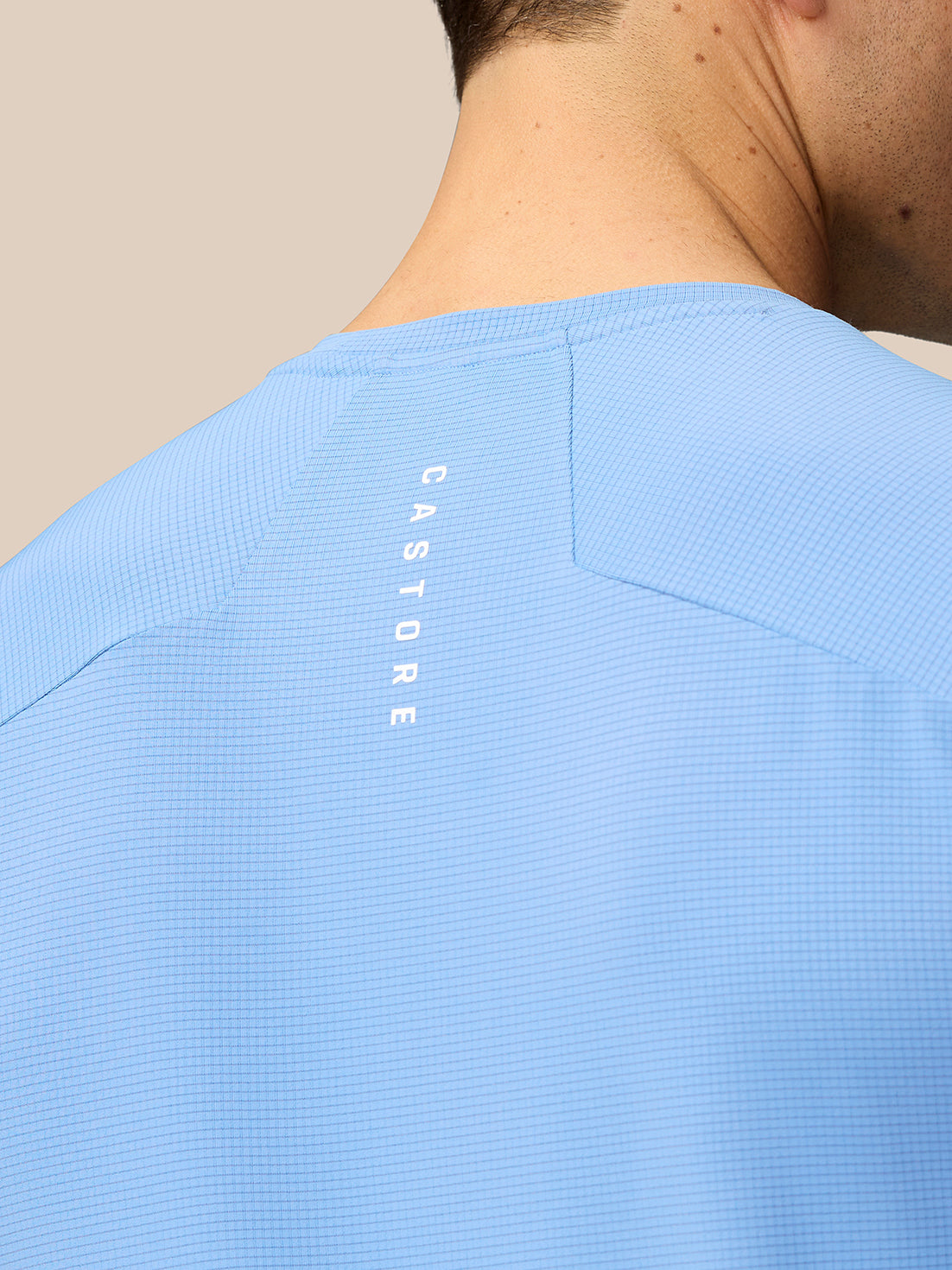 Back view of Sky Blue Apex Training T-Shirt showing vertical Castore branding.