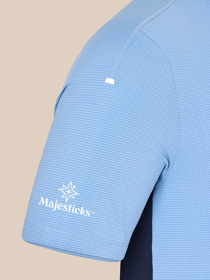 Close-up of sky blue Majesticks T shirt sleeve with grid fabric and Majesticks logo near the cuff