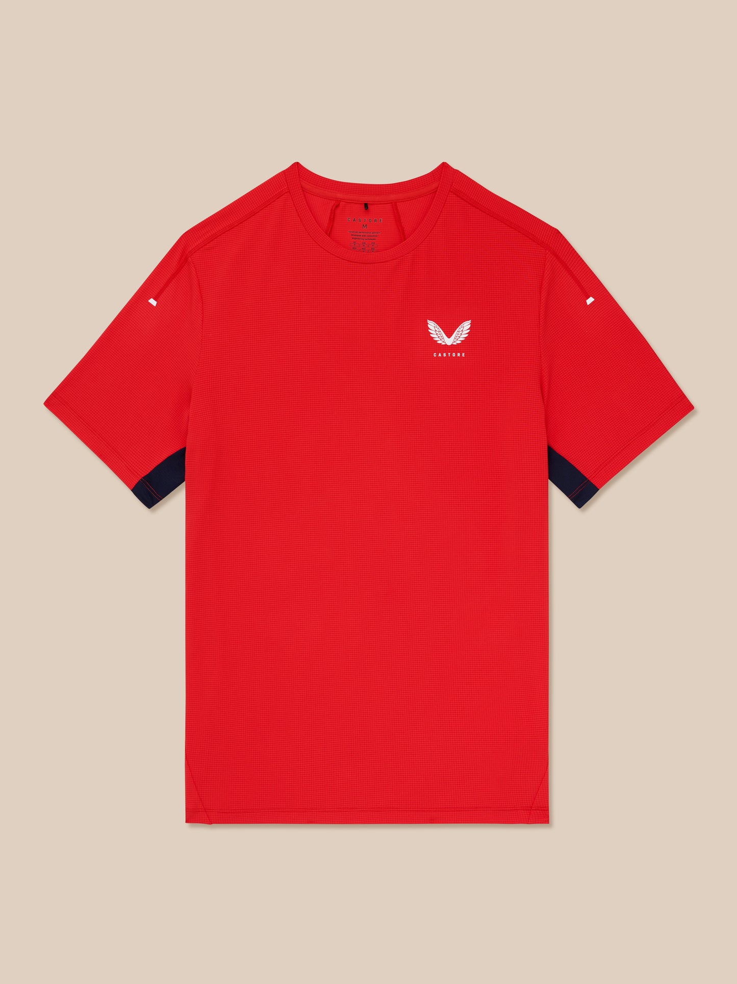 Close-up of the red Apex Training T-Shirt showing the white Castore logo on the chest and fabric texture.