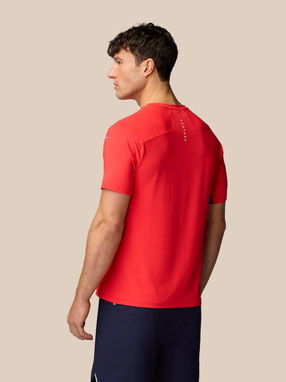 Back view of male model in red Apex Training T Shirt with vertical Castore branding along the upper back