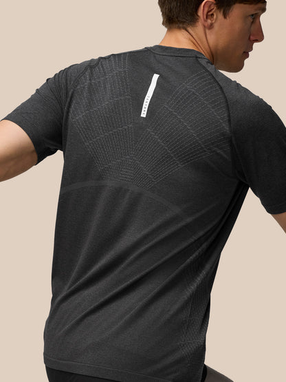 Back view of Flow Training T Shirt in dark charcoal showing a subtle back pattern and shoulder detailing