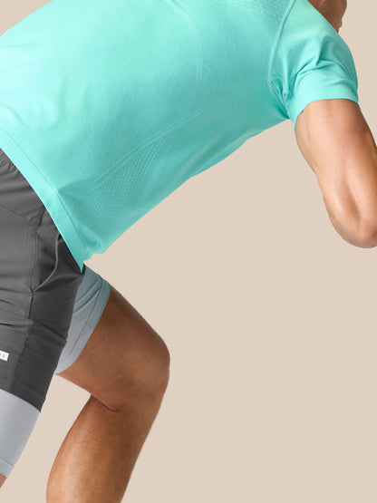 Close up of light aqua Flow Training T-Shirt fabric showing smooth knit and drape.