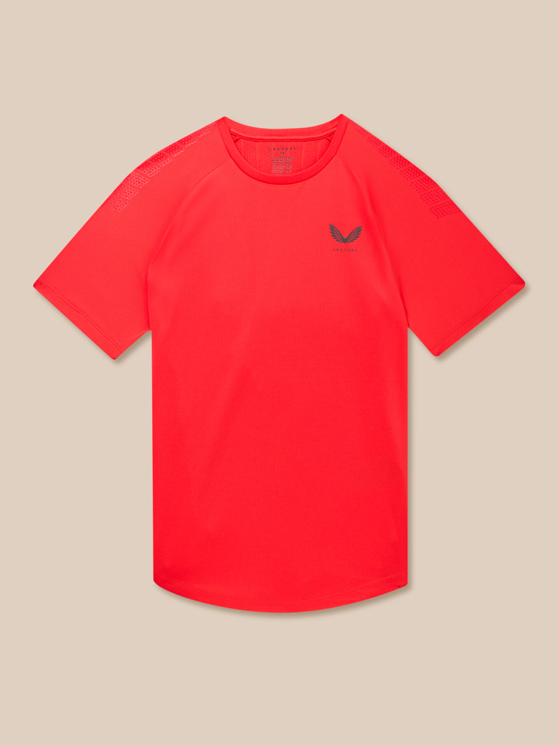 Red Flow Muscle Grip T-Shirt laid flat showing left chest logo against beige background