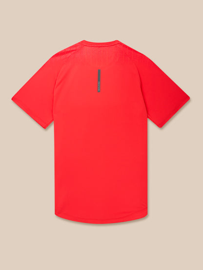 Back view of Flow Training Muscle Grip T Shirt in Poppy red with a vertical center back tag