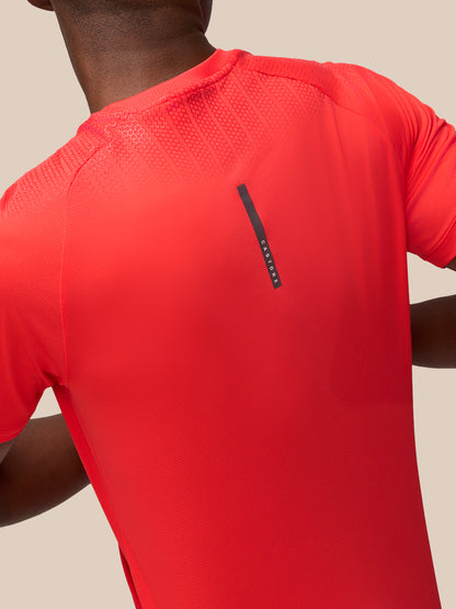 Back view of the red Flow Muscle Grip T Shirt showing shoulder texture and a vertical Castore label