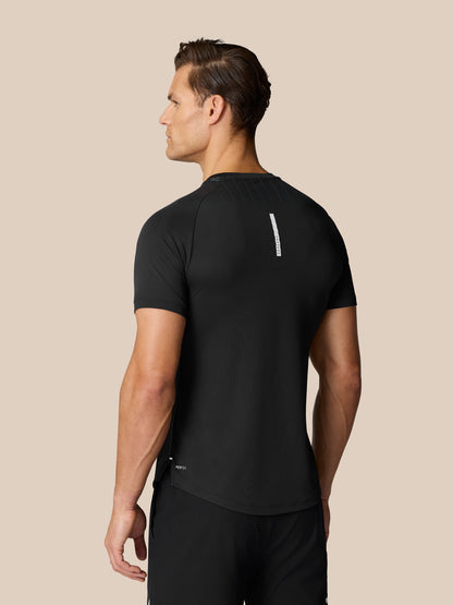 Back view of a man wearing a black Flow Training Muscle Grip T-Shirt with shoulder ventilation pattern and a vertical reflective strip on the upper back