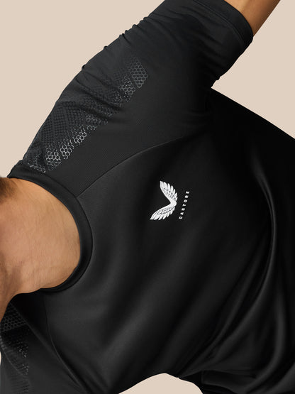Close up of the black Flow Training Muscle Grip T-Shirt shoulder area showing honeycomb ventilation panel and Castore branding