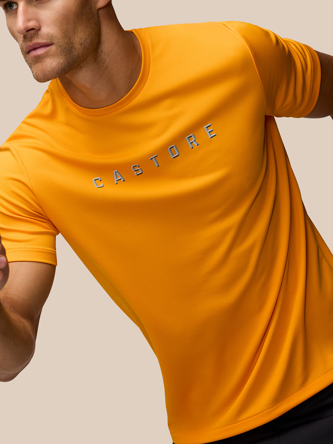 Angled shot of male model in Mango Castore graphic training T-shirt with logo across the chest.