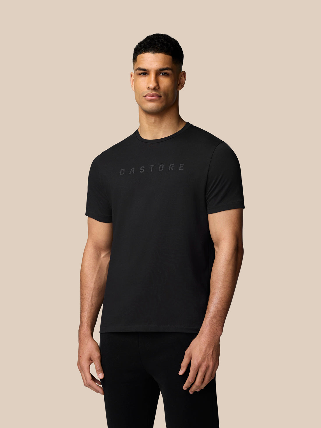 Male model in black Graphic Lifestyle T-Shirt with Castore logo across the chest.