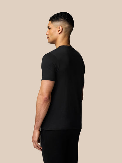 Side and back view of a man in a black graphic lifestyle T-shirt with drop shoulders