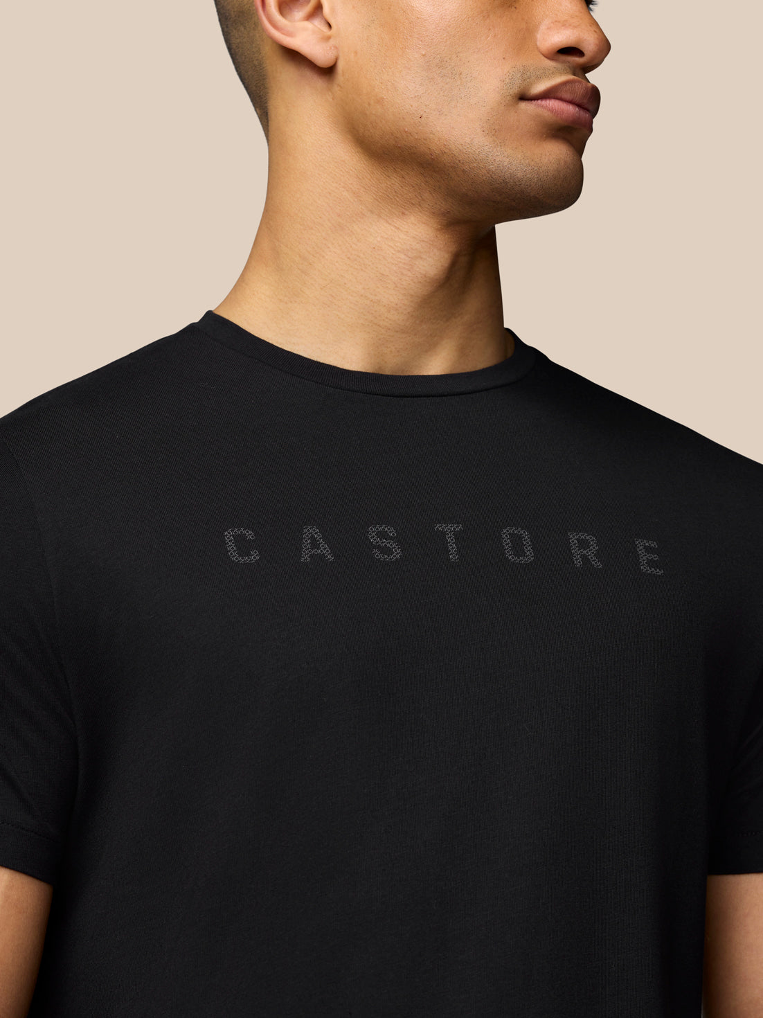 Close up of black T-shirt front showing the Castore graphic across the chest