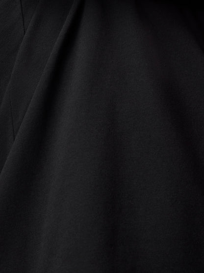 Close up of black cotton fabric with subtle texture and drape