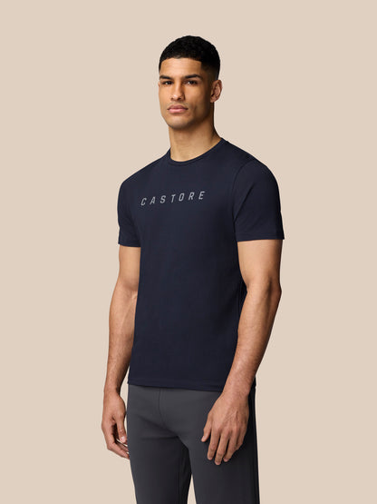 Male model wearing midnight navy graphic short sleeve T shirt with Castore logo on chest.