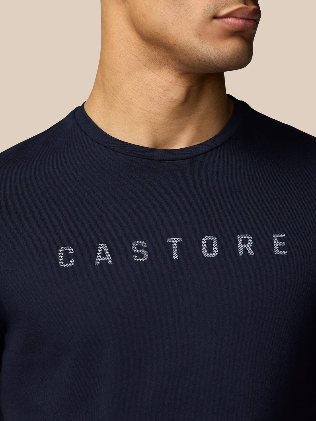 Close-up of navy graphic T shirt chest showing the Castore graphic