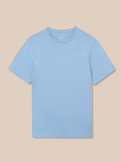 Sky blue graphic training t shirt laid flat with a small white Castore logo on the chest