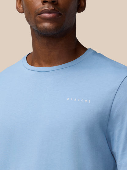 Front close-up of a sky blue Graphic Training T-Shirt with a small CASTORE logo on the chest