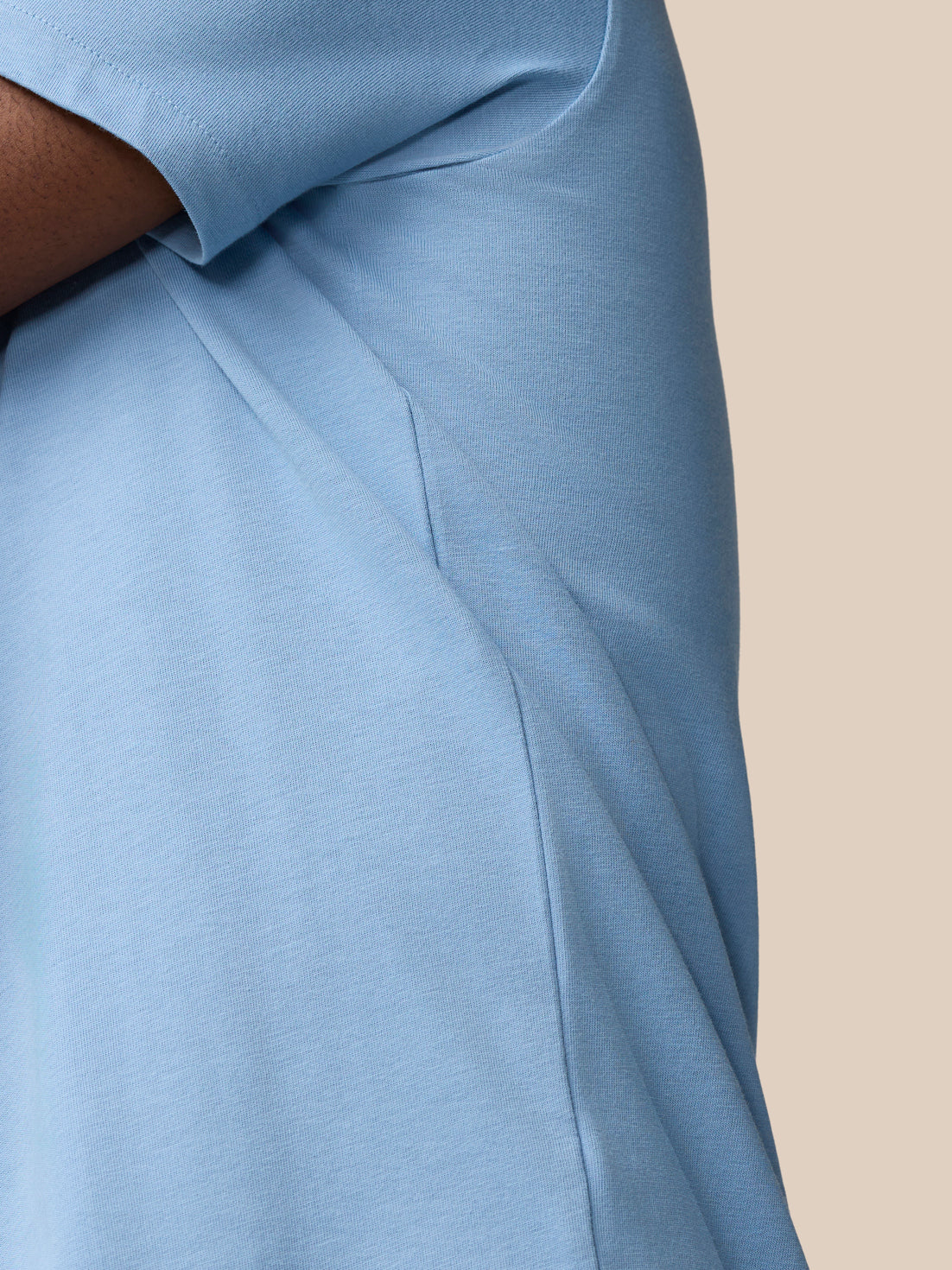 Side view of the sky blue Graphic Training T-Shirt showing the side seam and short sleeve