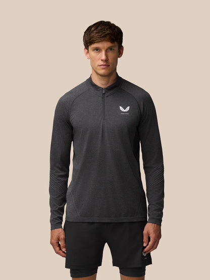 Front view of a model wearing Flow Training 1/4 Zip Top in black with chest branding