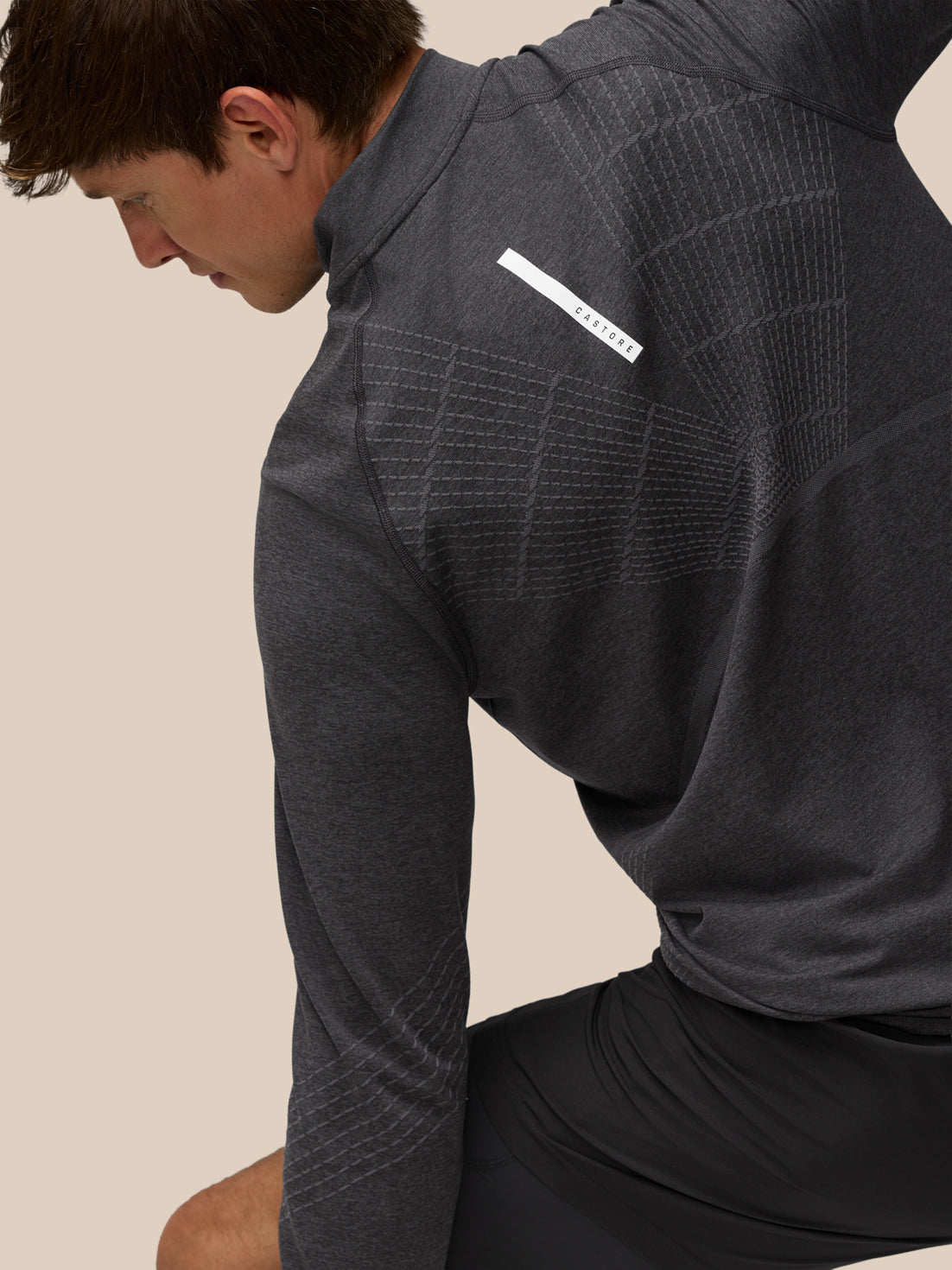 Back view of Flow Training 1/4 Zip Top in dark heather gray with knit back panels