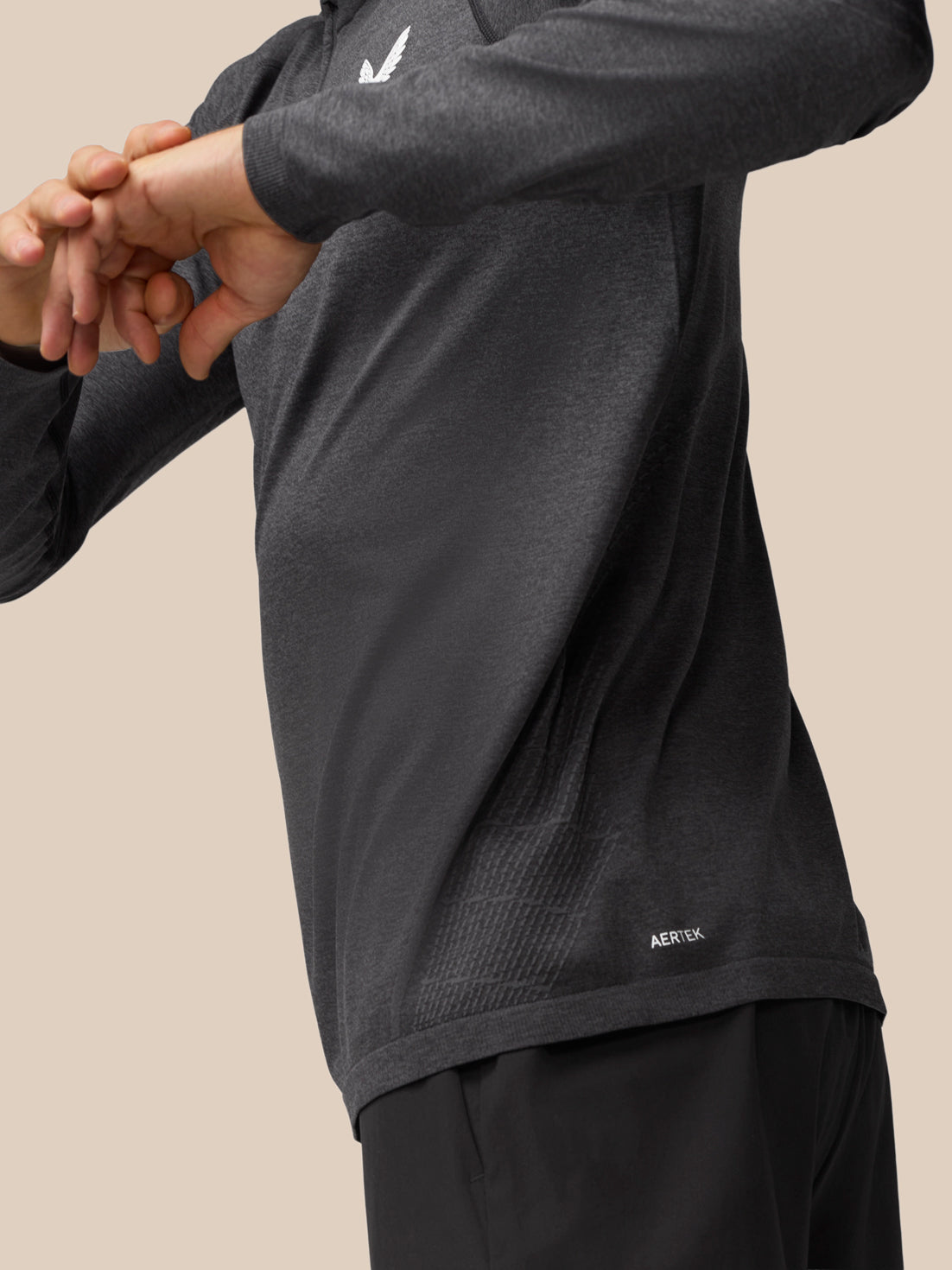 Flow Training 1/4 Zip Top in dark gray shown in side profile highlighting knit back panel and sleek silhouette