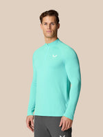 Flow Training 1/4 Zip Top in light aqua on model front view with Castore logo on chest