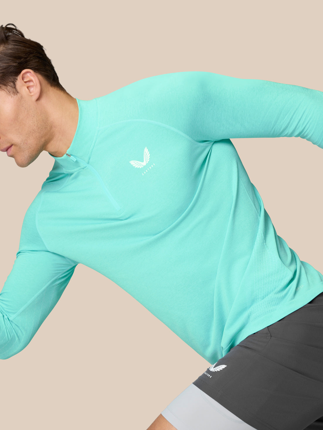 Side view of Flow Training 1/4 Zip Top in light aqua on a model, highlighting the zip collar and breathable back knit panels.