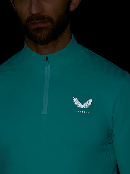 Teal Zone Training 1/4 zip top on a model with a high neck and white wing logo on the chest