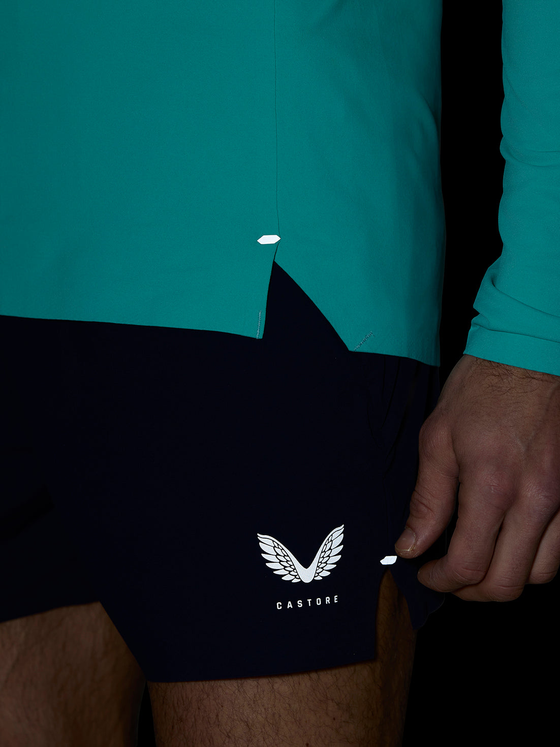 Teal Zone Training top from the hip area with curved hem and small reflective tab
