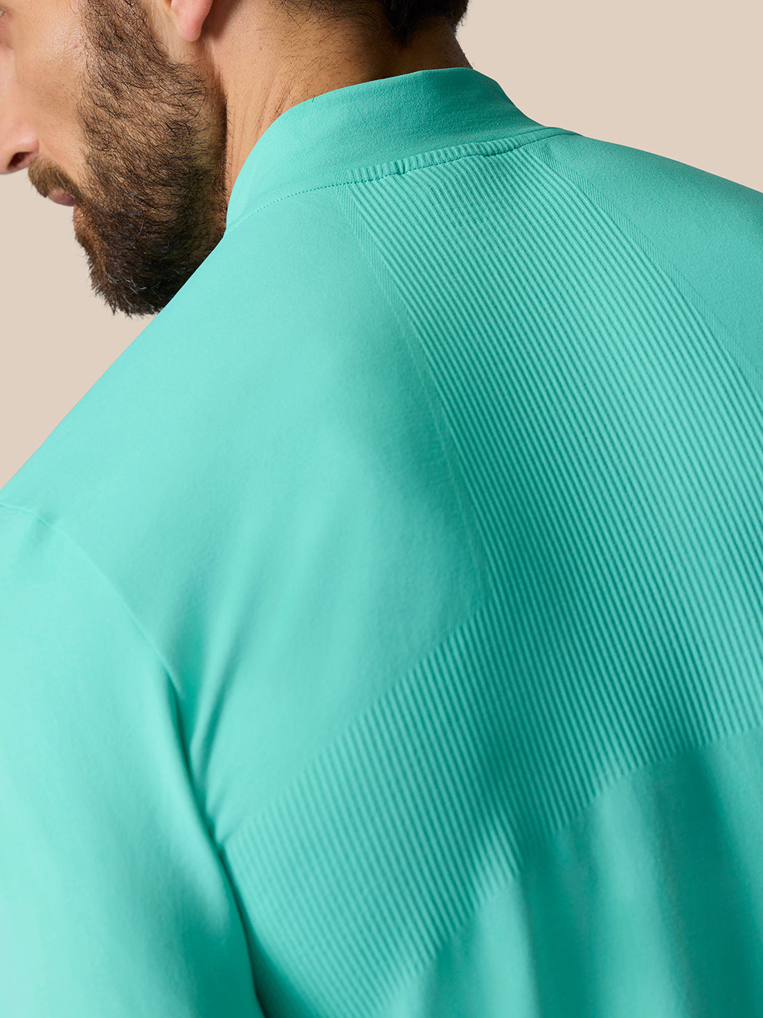 Close up of light aqua Zone Training 1/4 Zip Top shoulder showing ribbing and fabric texture