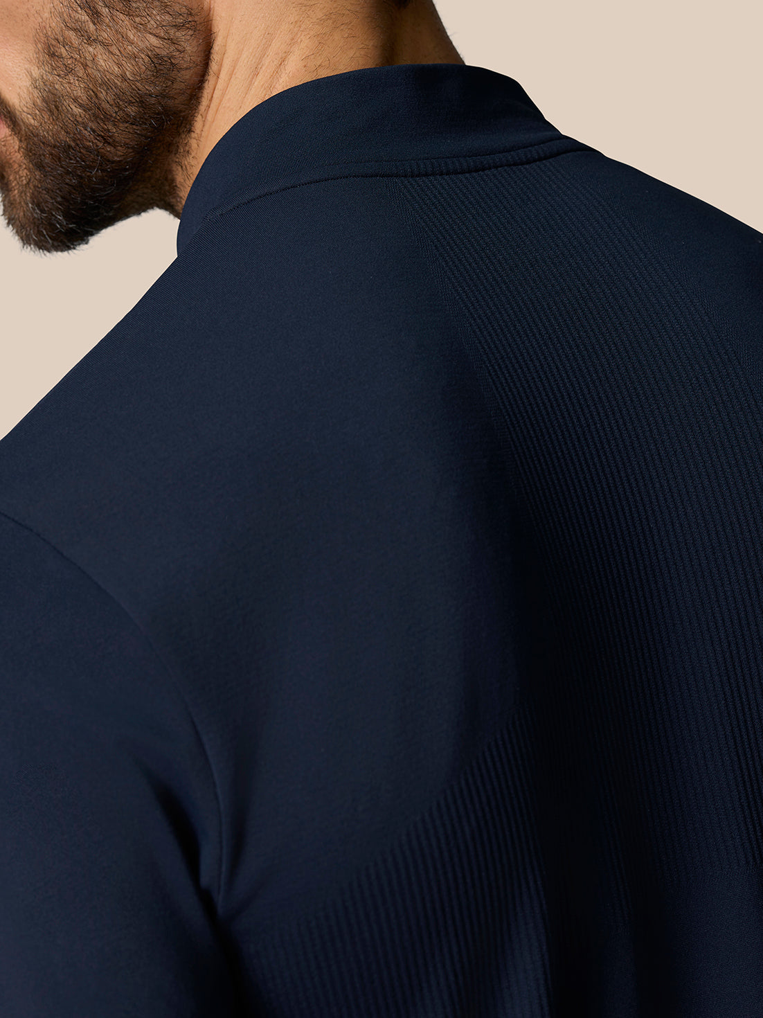 Shoulder close-up of navy Zone Training 1/4 Zip Top showing ribbed upper back paneling