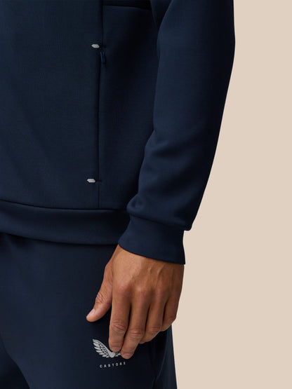 Close-up of navy Travel Lifestyle Zip Hoodie highlighting a zip pocket and Castore branding