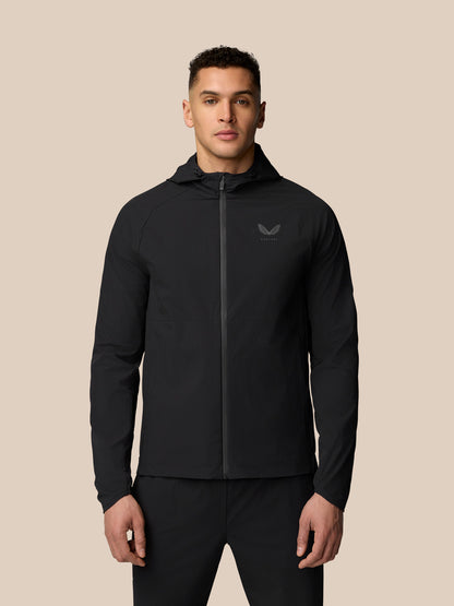 Man wearing black Adapt Training Wind Jacket with hood and front zipper.