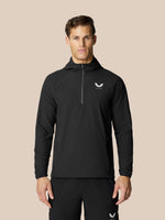 Man in black Flow Training Hoodie with half zip and white Castore logo on chest