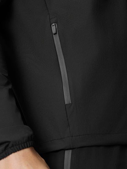 Close-up of black Flow Training Hoodie fabric featuring a vertical zip pocket