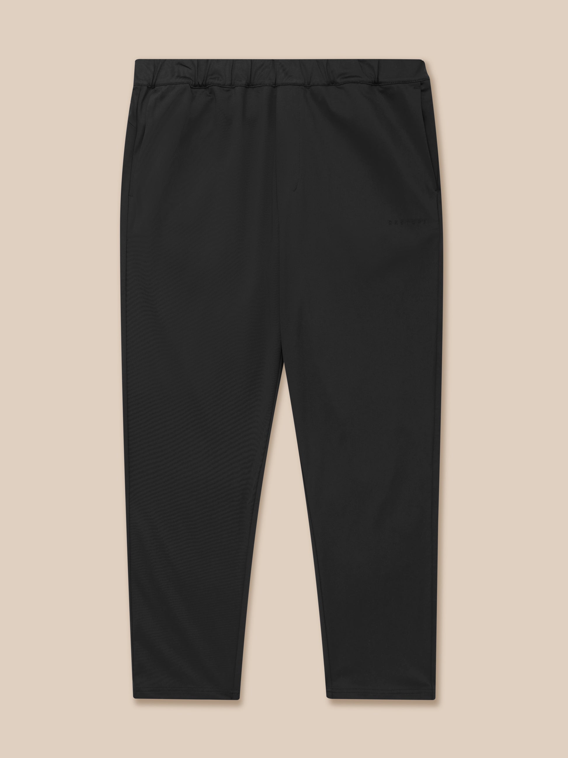 Close-up of black Elevated Lifestyle Tailored Trousers showing an elastic waist and subtle Castore branding along the leg