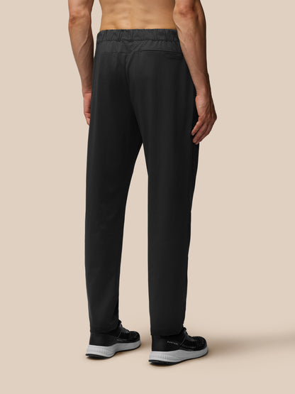 Rear view of a man in black tailored trousers with back pocket and sneakers
