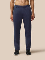 Front view of navy Elevated Lifestyle Tailored Trousers with elastic waist and Castore wordmark on left leg.